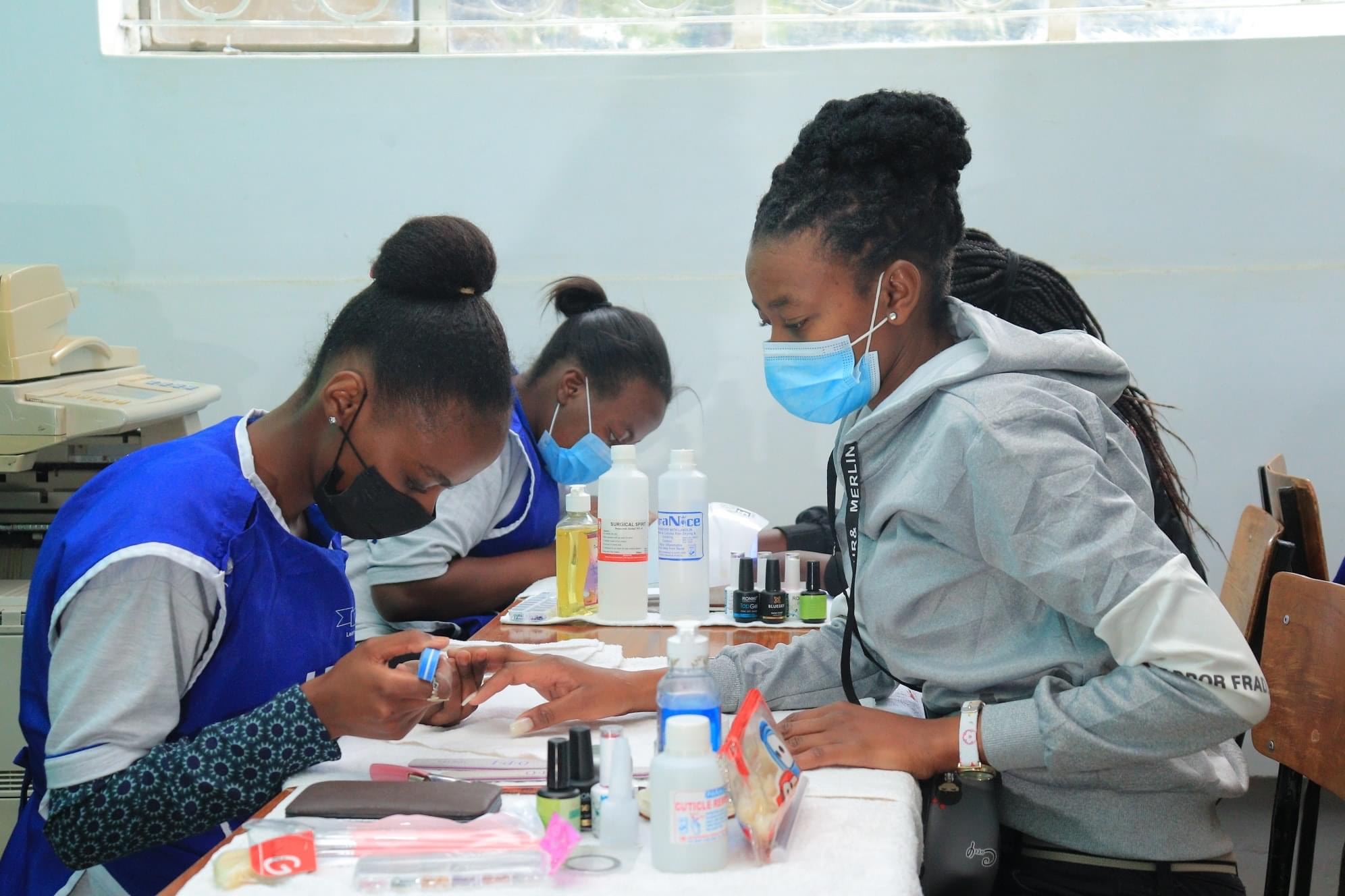 Unity College students receiving practical nail technology training